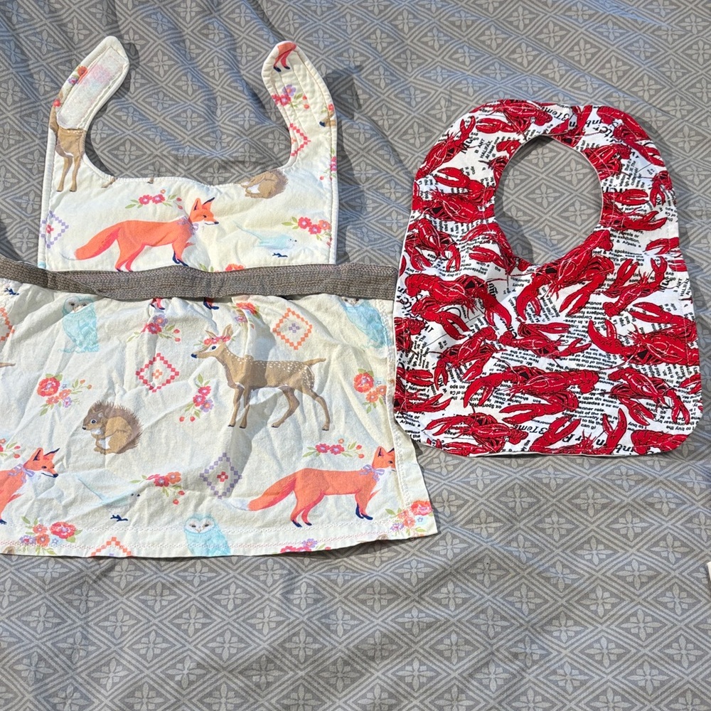 Two bibs. Lobster like new, woodland creatures apron style used condition